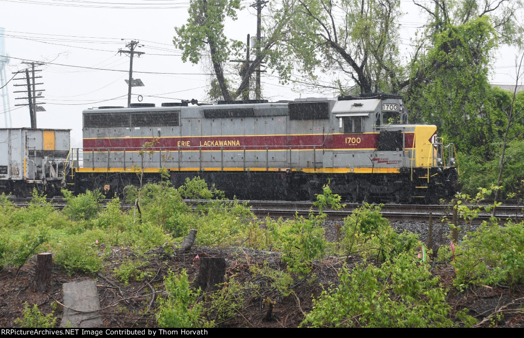 NS 1700 stands idle on a rainy Sunday with its ballast cars